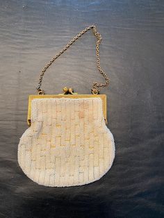 "Vintage White Beaded purse or clutch. The beads are white on this but it has a nice mulitcolored stitching that makes an interesting lightly colored pattern. You should be able to see this if you zoom in. It is about 4.5\" x 4\" with a metal top clasp and chain. It is in pretty good overall condition. There doesn't appear to be any bead loss on it. There is a stain in the liner (the darker spot in the closeup of the liner) Metal clasp piece has some tarnish on it, but not too bad.  Packaged car White Beaded Evening Clutch, White Beaded Clutch, Vintage White Clutch For Party, Vintage Evening Clutch With Pearl Handle, Vintage White Beaded Clutch, Ladies Clutch, White Beads, Pretty Good, Clutch Handbag