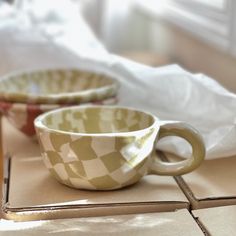 two coffee cups sitting on top of a counter