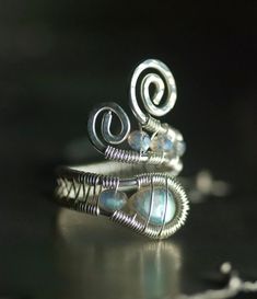 two silver rings sitting on top of a table