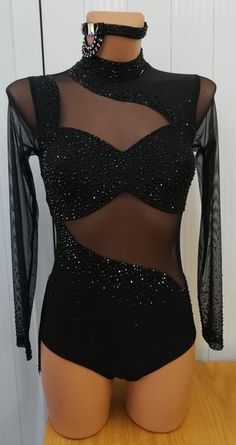 a black bodysuit with sheer mesh and sequins on the top, sitting on a mannequin