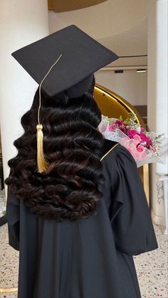 a woman wearing a graduation cap and gown