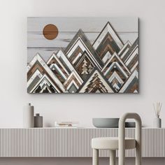 a painting hanging on the wall above a table