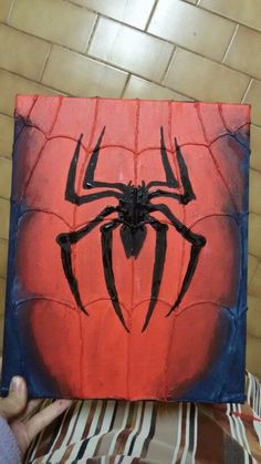 a spider man painting on an orange and blue canvas