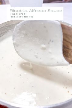 a spoon full of white sauce in a pot