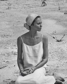 a woman sitting on the ground with her eyes closed