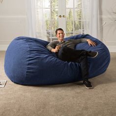 a man sitting on a large blue bean bag chair