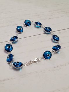 "925 Sterling Silver Crystal Murano Glass Evil Eye Protection Bracelet Sparkling Round, murano glass evil eye's linked together to form a protection bracelet 7 inch length, Strong lobster clasp, stamped \"925\" Can be made longer, just message me :) Evil eye charms measure 10mm each Solid 925 Sterling Silver; stamped \"925\" for authenticity. Arrives in a gift box Bracelet is made to order- Bracelet in photos is an example only. A Symbol of protection- When a person wears or carries an evil eye Sterling Silver Evil Eye Bracelet, Silver Evil Eye Bracelet, Long Cross Necklace, Glass Evil Eye, Bracelet Evil Eye, Eye Symbol, Evil Eye Protection, Silver Link Chain, Evil Eyes