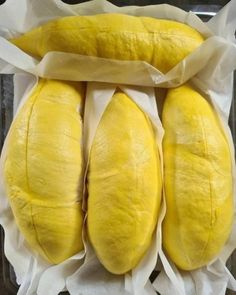 three loaves of bread wrapped in wax paper