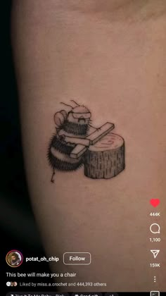 a small tattoo on the side of a woman's thigh with a bee sitting next to a piece of wood