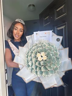 a woman holding a bouquet of flowers in front of a door with congratulations written on it