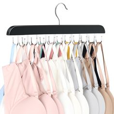 an assortment of bras hanging from a rack on a hanger against a white background