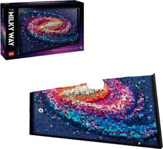 the puzzle box is made up of colorful beads and has a large piece of artwork on it