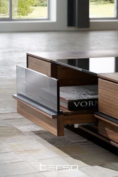 a coffee table with an open book on it's shelf and the word vorn written in black