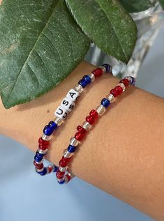 Red, white, and blue beads with USA name Everyday Red Stretch Bracelet With Round Beads, Patriotic Blue Beaded Stretch Bracelet, Patriotic Round Beads Stretch Bracelet For 4th Of July, Patriotic Blue Friendship Bracelets, Blue Patriotic Bracelet For Friendship, Patriotic Multicolor Stretch Bracelet For 4th Of July, Blue Beaded Patriotic Stretch Bracelet, Multicolor Round Beads Bracelet For 4th Of July, Patriotic Blue Friendship Bracelet