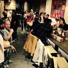 a group of people sitting at tables in a restaurant