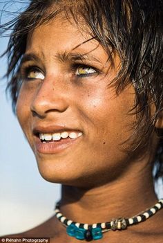 a close up of a person wearing a necklace with beads on it's neck