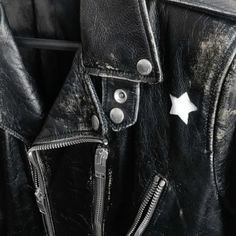 a black leather jacket with white stars on it