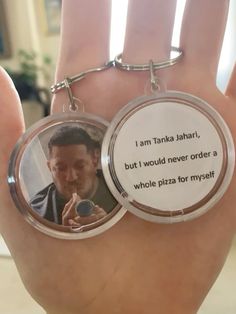 a hand holding a keychain with a picture of a man on it and a quote from the movie, i am tanka jahan, but i would never order a whole pizza for my self