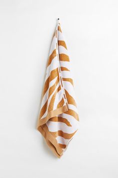 an orange and white towel hanging on the wall