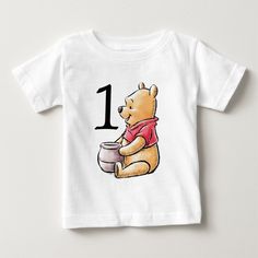 a baby t - shirt with a winnie the pooh cartoon on it's chest