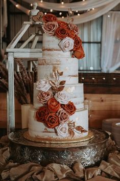 a three tiered cake with flowers on it