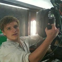 a young man is working on an engine in a vehicle that has been modified to look like a spaceship