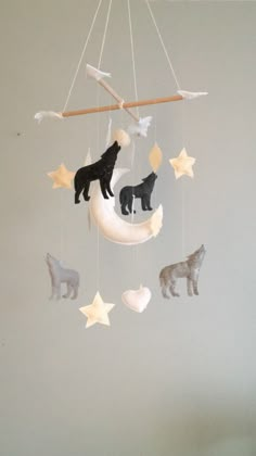 a mobile with animals hanging from it's sides in the shape of moon and stars