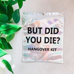 a sticker that says, but did you die? hangover kit next to some green leaves