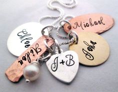 four different necklaces with names on them and pearls hanging from each one's neck