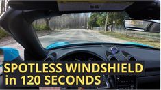 the inside view of a car driving down a road with text that reads spotless windshield in 120 seconds