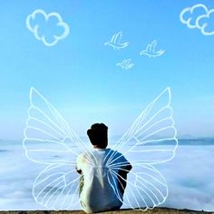 a man sitting on top of a rock next to clouds