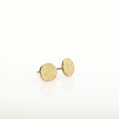 "Gold earrings, round simple and perfect for every day's wear. These organic stud earrings are hand fabricated from yellow 14k solid gold. I melted the gold and then hammered it to its irregular shape. No two are ever identical; each has a unique and organic look. The edges of the pebbles are rough, while the flat surface has a delicately scratched brushed finish. These are classic, minimalist, \"wear with everything\" gold earrings - a perfect gift, or a treat for yourself. Earrings diameter is Classic Hammered Earrings For Everyday, Classic Hammered Earrings For Anniversary, Round Recycled Gold Earrings As Gift, Everyday Hammered Yellow Gold Earrings, Everyday Yellow Gold Hammered Earrings, Classic Round Earrings In Recycled Gold, Minimalist Hammered Round Disc Earrings, Classic Round Recycled Gold Earrings, Hand Forged 14k Gold Round Earrings