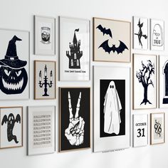 a bunch of pictures hanging on the wall in a room with halloween decorations and pumpkins