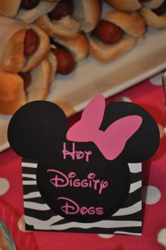 there is a hot dog buns and some other food items on the table with minnie mouse ears