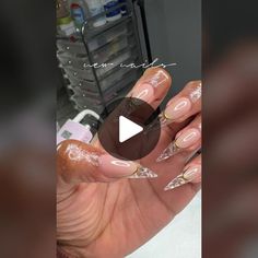 a woman's hand holding some fake nails