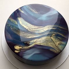 a blue and gold plate sitting on top of a white countertop next to a wall