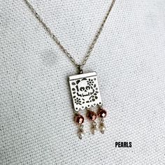 This exquisite Joyeria Plata necklace, featuring a unique Papel Picado pendant, is a masterpiece of Mexican craftsmanship. Handcrafted with meticulous attention to detail, it echoes the rich cultural heritage of Artesanias Mexicanas. The delicate Papel Picado design, a traditional Mexican folk art, is beautifully rendered in silver, making this Taxco necklace a captivating piece of Joyeria Mexicana. Adorned with intricate patterns, it captures the vibrant spirit of celebrations like Cinco de Mayo and Dia de los Muertos. This Mexican silver necklace is more than just an accessory; it's a symbol of Mexican tradition and artistry. With its fine craftsmanship and unique design, it stands out as a stunning representation of Taxco's renowned silverwork. The Papel Picado pendant adds a touch of e Artisan Silver Etched Necklace, Copper Beaded Pendant Jewelry, Beaded Copper Pendant Jewelry, Sterling Silver Dangle Necklace For Festivals, Artisan Pearl Pendant Necklace, Silver Etched Square Pendant Necklace, Sterling Silver Nickel-free Necklace For Festivals, Silver Long Pearl Necklace For Celebrations, Elegant Etched Necklace As A Gift