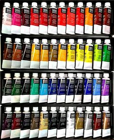 the shelf is full of different colors of paint in it's display case,