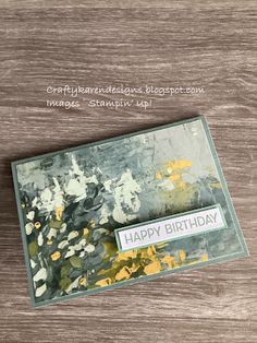 a close up of a birthday card on a wooden surface with the words happy birthday