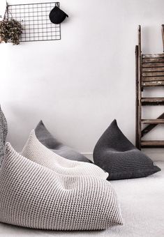 some pillows are sitting on the floor next to a chair