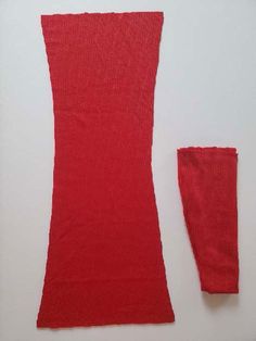 a piece of red knitted material next to it's sleeve and leggings