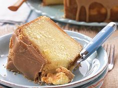 a piece of cake on a plate with a knife and fork in front of it