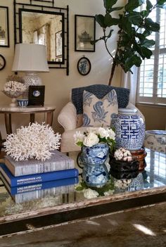 a living room filled with lots of furniture next to a wall covered in framed pictures