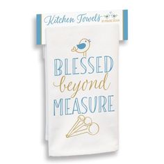 a kitchen towel with the words,'blessed beyond measure'in gold and blue