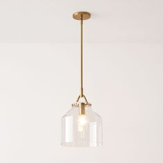 a clear glass light fixture hanging from a ceiling