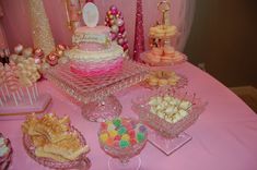 a pink table topped with lots of desserts