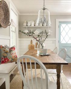 a dining room table with chairs and plates on it