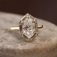 a diamond ring sitting on top of a marble slab