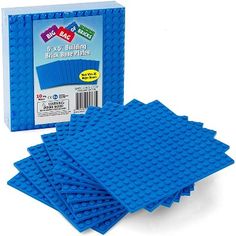 four blue lego coasters sitting next to each other