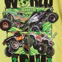 a yellow shirt with monster trucks on it